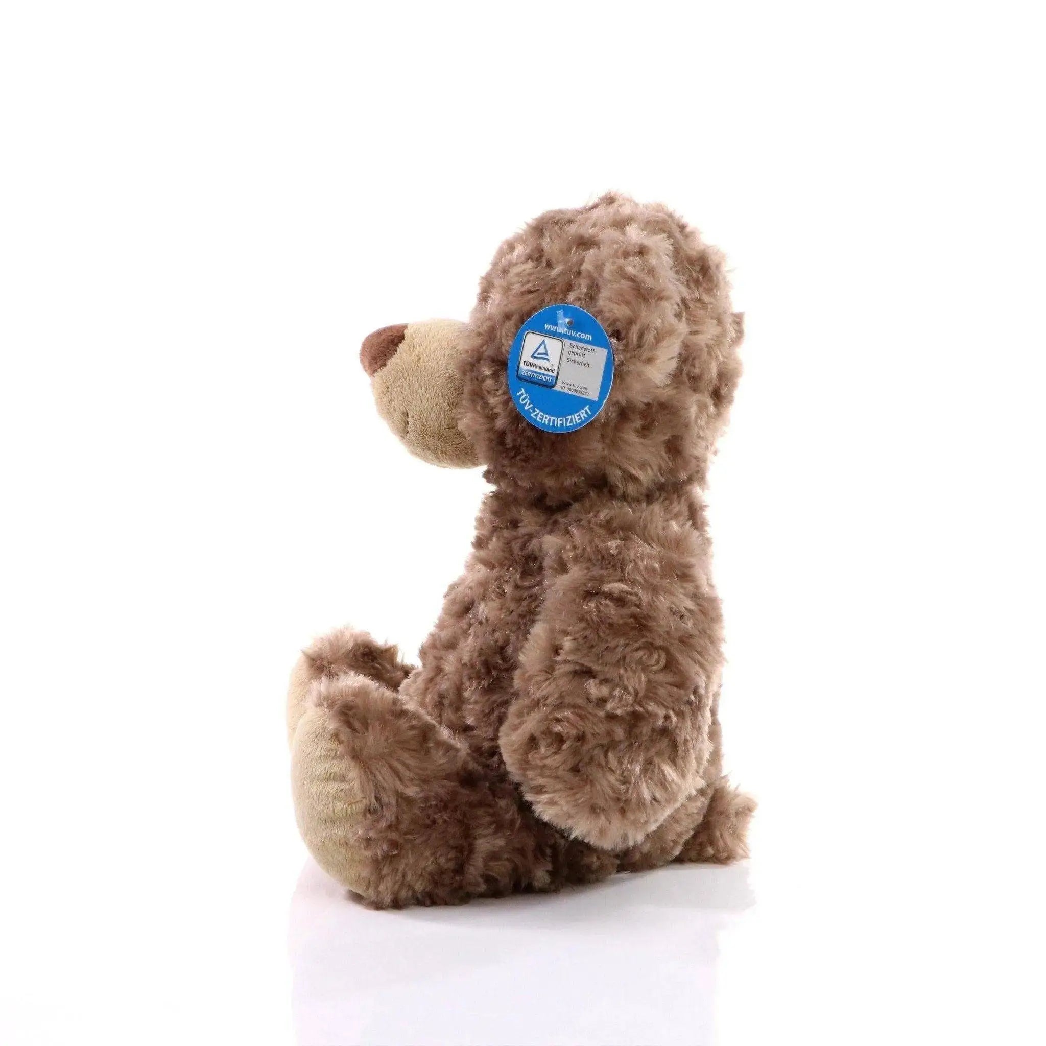 Ein brauner bär bodo plüschbär mit lockigem fell und beiger schnauze und pfoten als kuscheltier