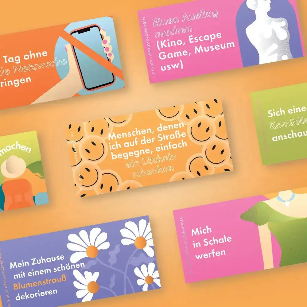Bunte rechteckige karten mit fröhlichen smileys und deutschen texten für das kartenspiel challenge-box 30 glücks herausforderungen