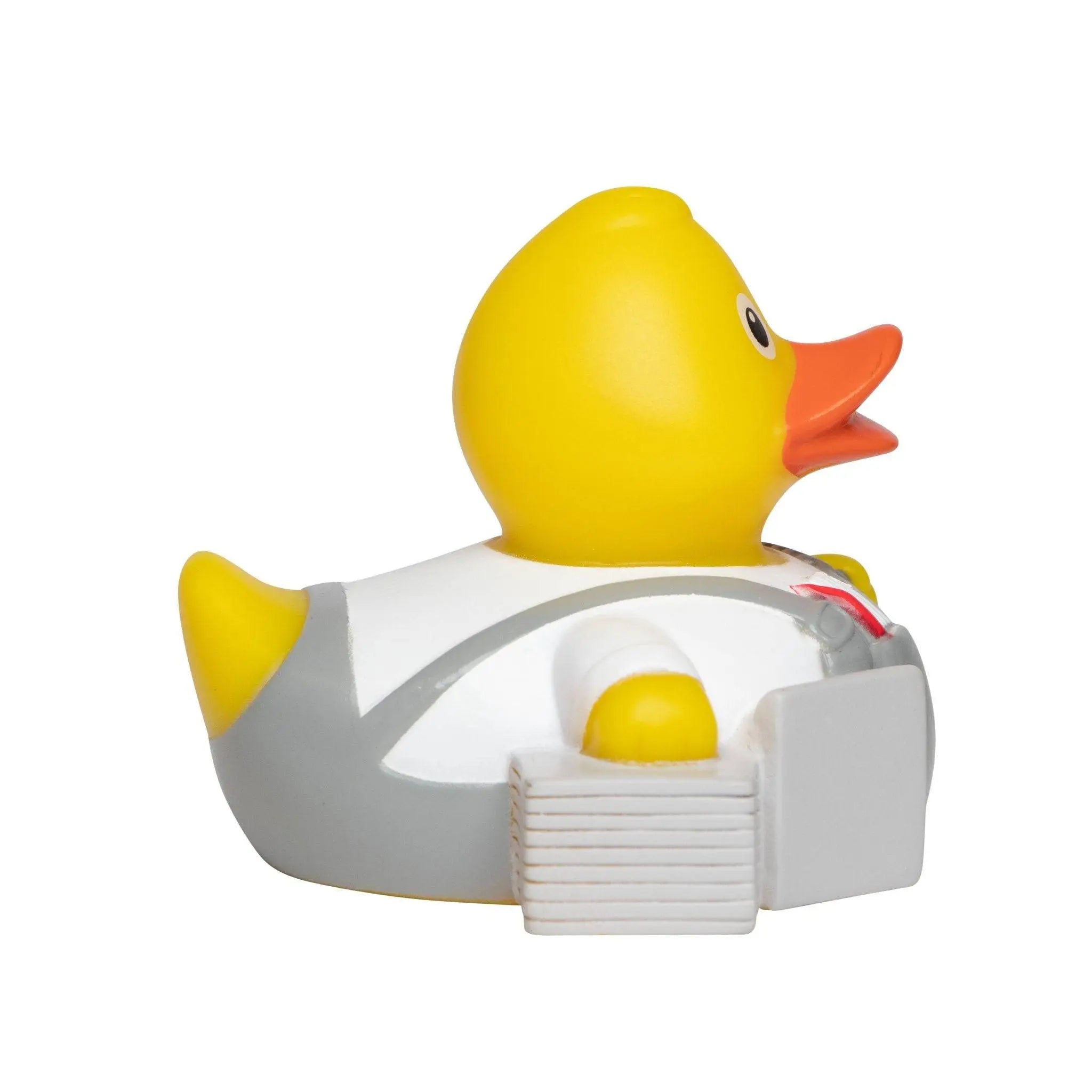 Fließenleger badeente in gelb mit grauem astronautenanzug und orangefarbenem schnabel als quietsche-ente