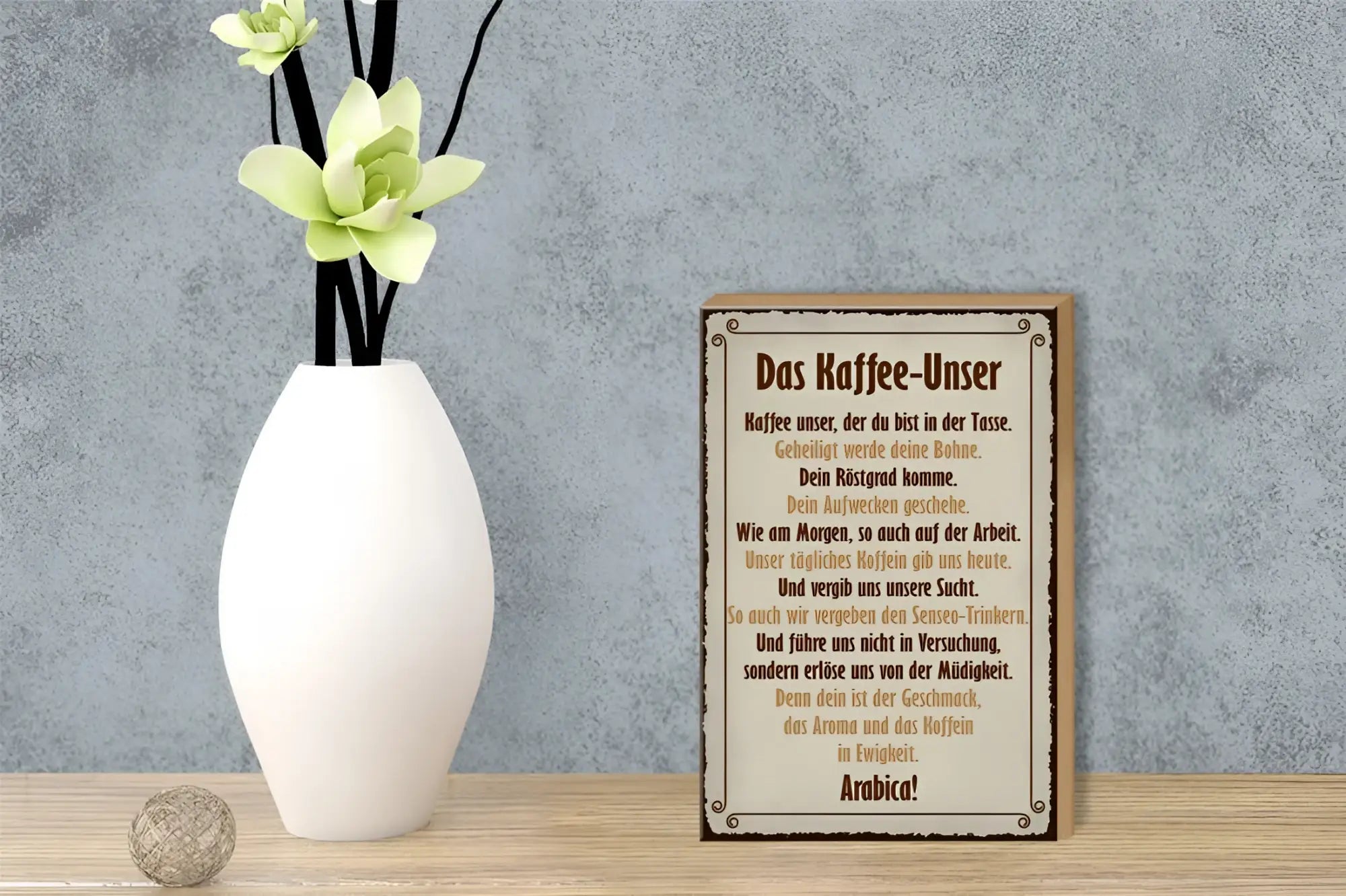 Weißes keramikvase mit schwarzen stielen und blassgrünen blumen neben holzschild kaffe unser 12x18cm