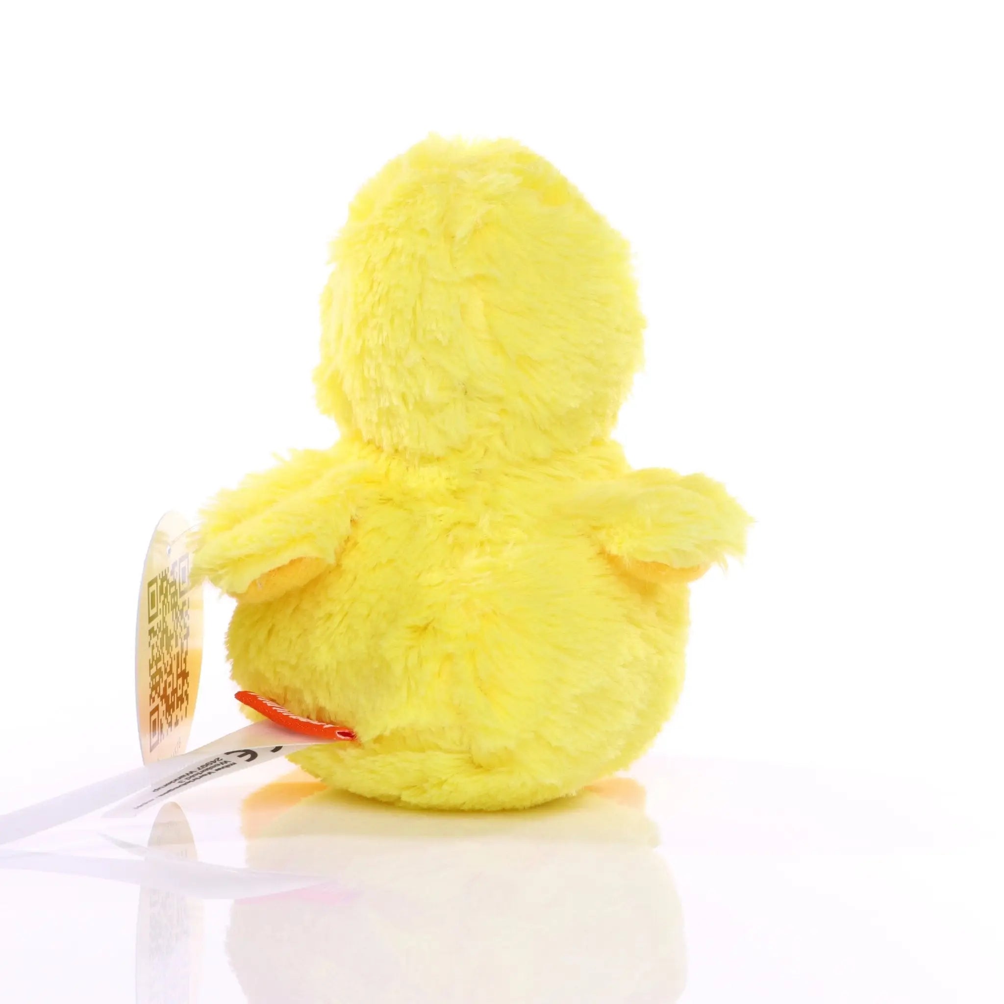 soft bright gelb plush Ente toy küken nelli mit fluffy Textur und klein rot tag auf its back