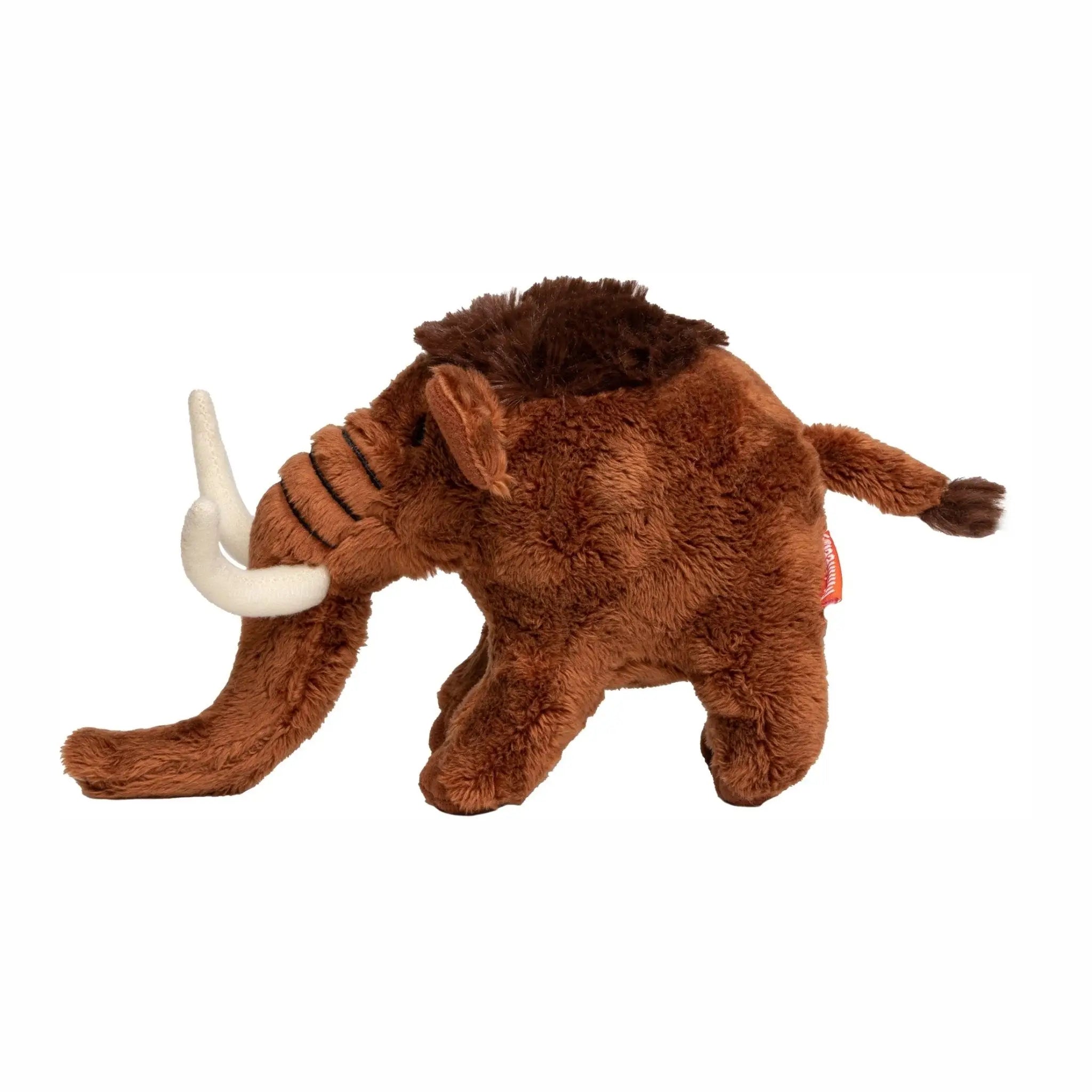 Brauner plüschtier mammut mit weißen stoßzähnen und dunkelbraunem schopf aus stoff mammut manni