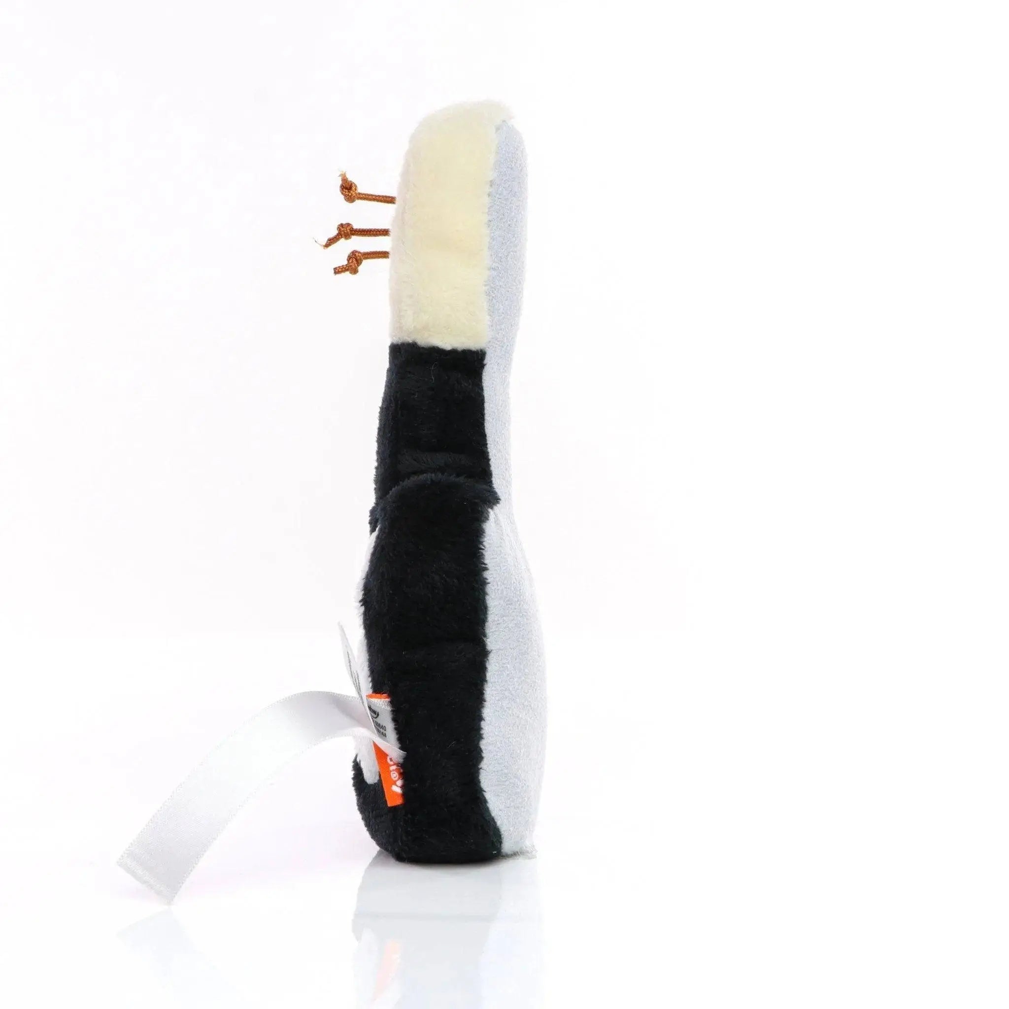 Black and white plush penguin shaped schmoozies displayreiniger gitarre with orange plastic feet