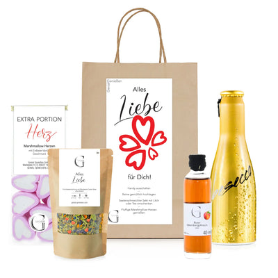 Goldfarben metallic flasche mit schwarzem deckel und kursivem logo im alles liebe für dich geschenktüte präsentkorb