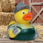 Gelbe Quietscheente von Bauer als Landwirt mit grauem hut grünen overall und silbernen handschuhen