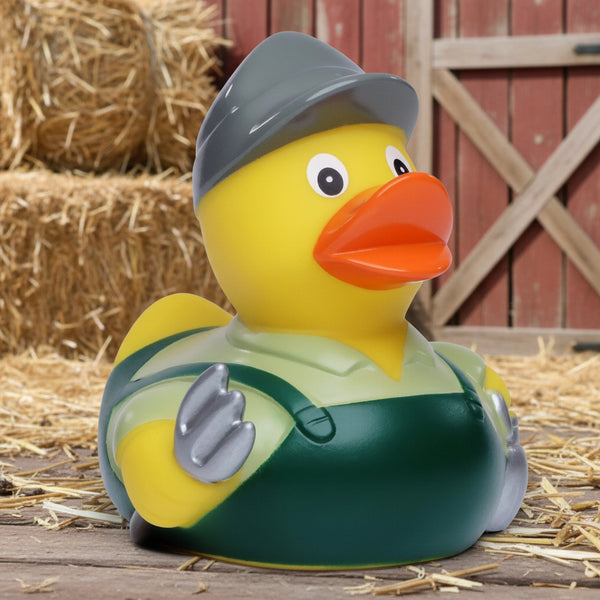Gelbe Quietscheente von Bauer als Landwirt mit grauem hut grünen overall und silbernen handschuhen