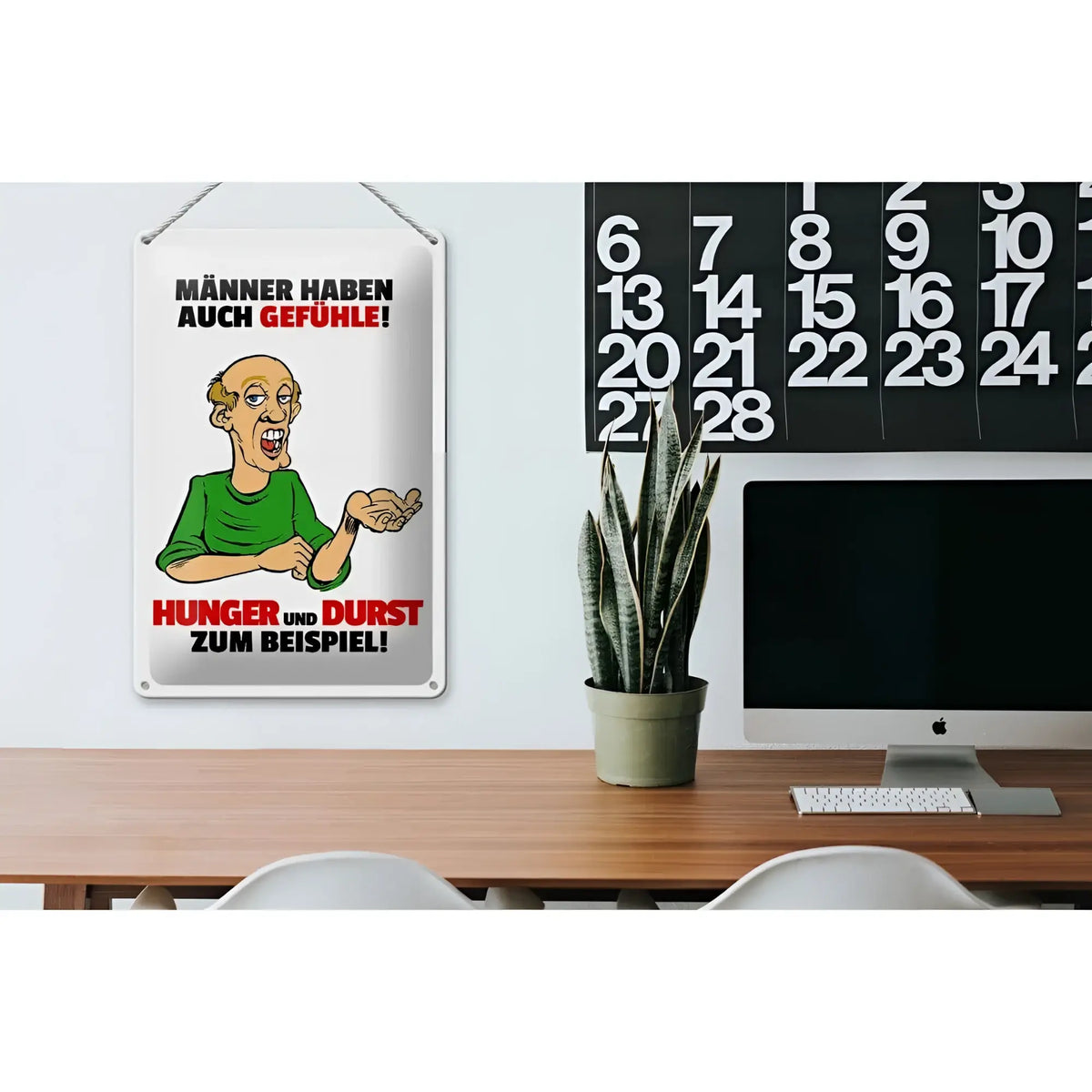 Weißes rechteckiges blechschild mit cartoon eines mannes im grünen shirt und rotem schwarzem text männer haben auch gefühle