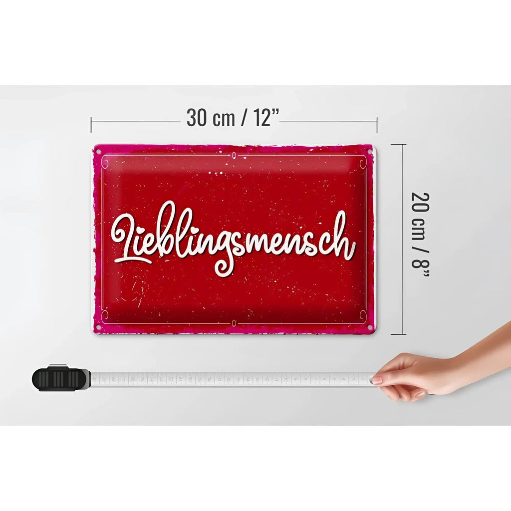 Rotes blechschild 30x20cm mit weißem lieblingsmensch schriftzug in kursive und rosa rahmen