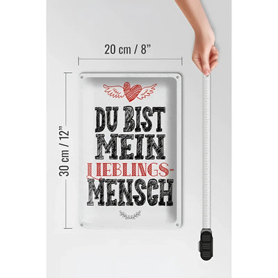 Weißes rechteckiges blechschild mit vintage design und schwarzem rotem text du bist mein lieblingsmensch und herz mit flügeln