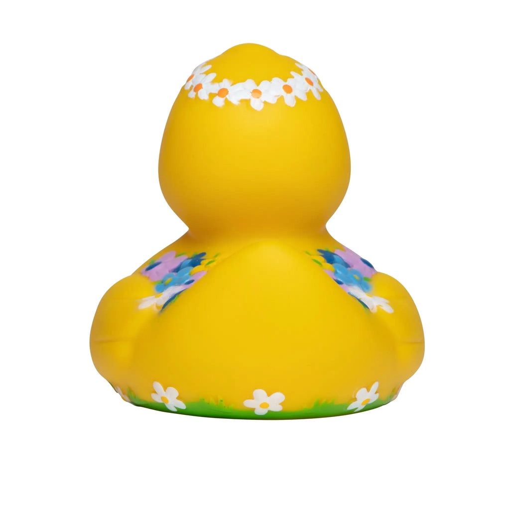 quietsche-ente badeente in leuchtendem gelb mit weißen kräutern und lila-blauen floralen mustern
