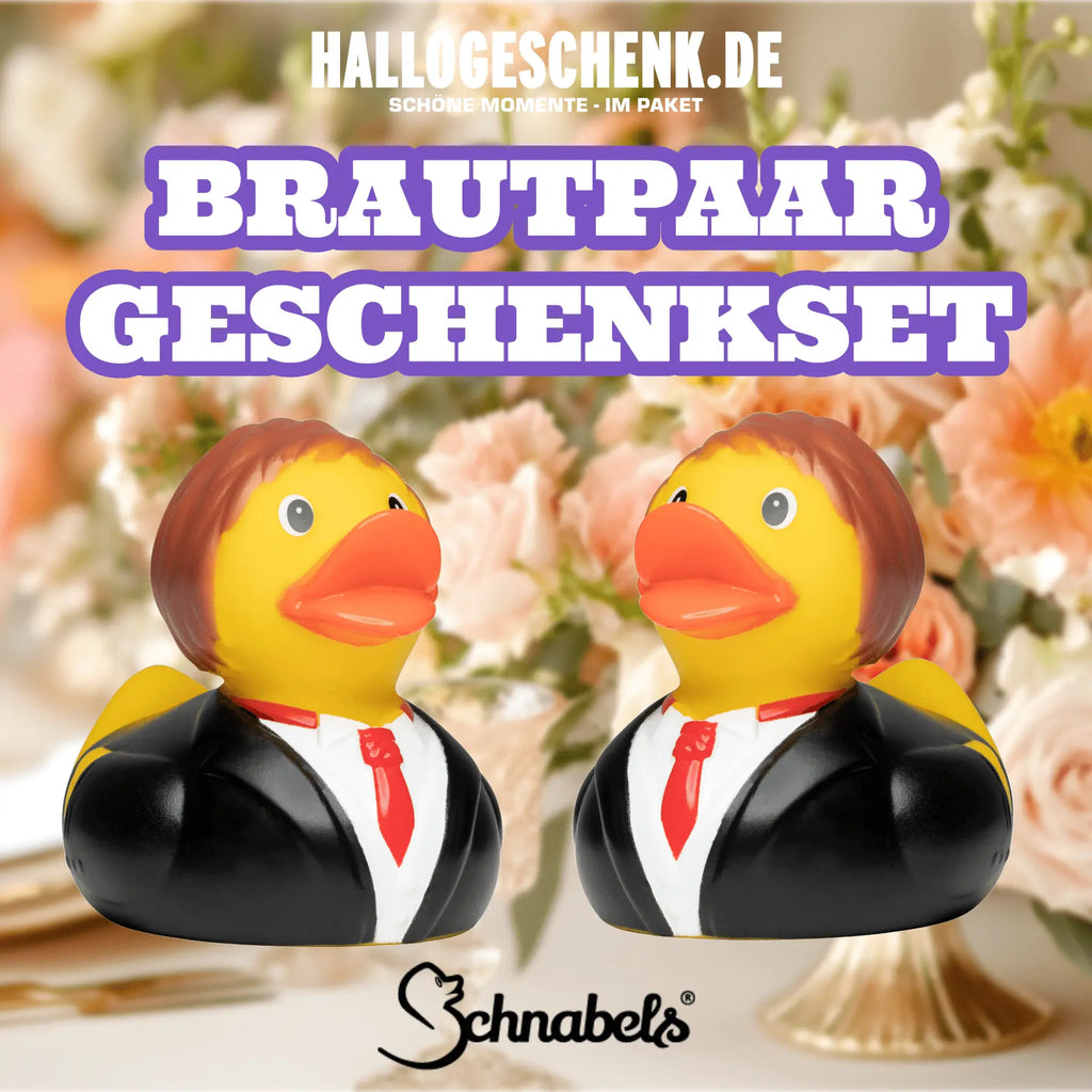 Ein set aus gelben quietscheenten als brautpaar mit schwarzen tuxedos und roten krawatten für hochzeiten