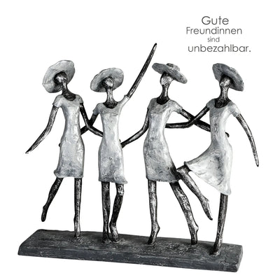 Silberfarbene kunstharz skulptur von vier stylisierten frauen mit hüten die sich an den händen halten auf dunklem sockel
