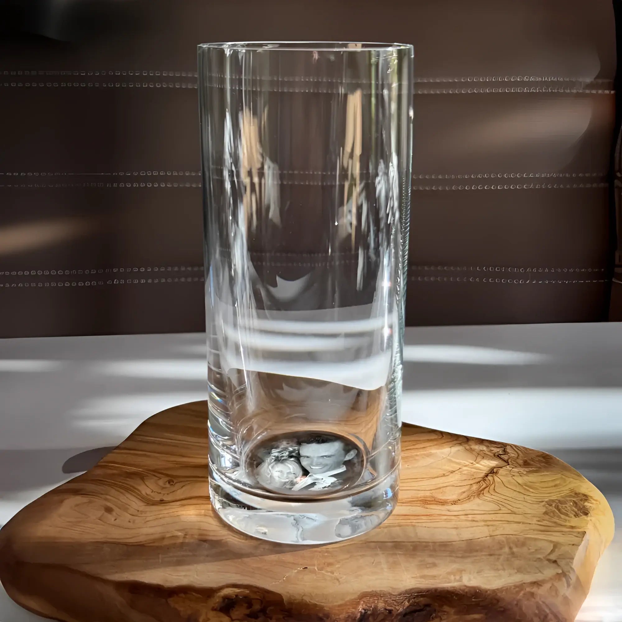 Klarer zylindrischer glasvase mit subtiler gravur und reflektierender basis für dein foto im glas longdrink set