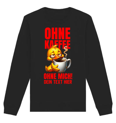 Schwarzes langarmshirt mit gelber cartoonente, die aus einer weißen kaffeetasse trinkt, mit rotem deutscher schriftzug