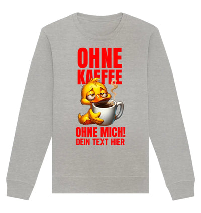 Graues langarm sweatshirt mit gelber cartoonente, die aus einer weißen kaffeetasse trinkt, und rotem deutschen statement text
