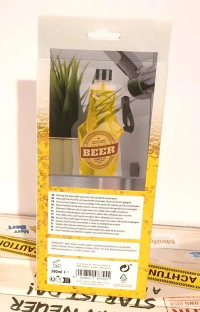 Gelbes plastikspielzeug in bierflaschenform mit braunem etikett und schwarzem verschluss für duschgel mit zitronenduft