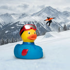 Eine gelbe quietsche-ente im snowboarder-look mit schwarzem helm, roten goggles und blauer skijacke