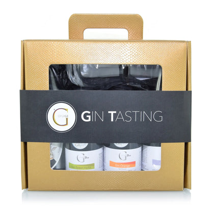 Gold strukturierte geschenkbox mit schwarzem band gin tasting mit drei kleinen flaschen und glas fürs probieren
