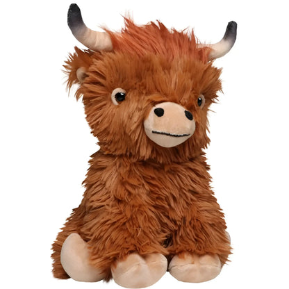A plush highland cow toy hochlandrind bobby with fluffy orange brown fur black and white horns and soft beige paws