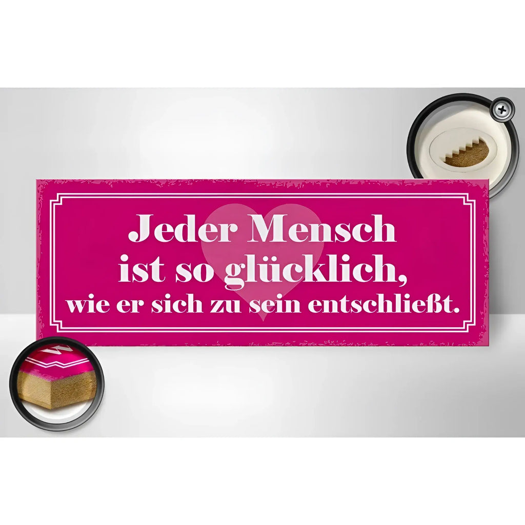 Ein pinkes holzschild mit weißem text und herzmotiv mit dem spruch jeder mensch ist so glücklich zur deko