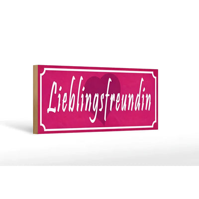 Ein pinkes rechteckiges holzschild mit weißer kursiver schrift und herzdesign als lieblingsfreundin geschenk