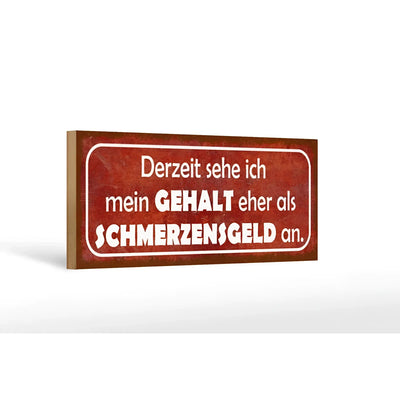 Rotes rechteckiges holzschild 27x10cm mit weißem spruch derzeit sehe ich mein gehalt eher als schmerzensgeld an
