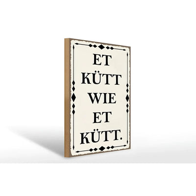 Creamfarbenes holzschild 30x40cm mit schwarzem kölschen spruch et kütt wie et kütt und diamantmuster rahmen