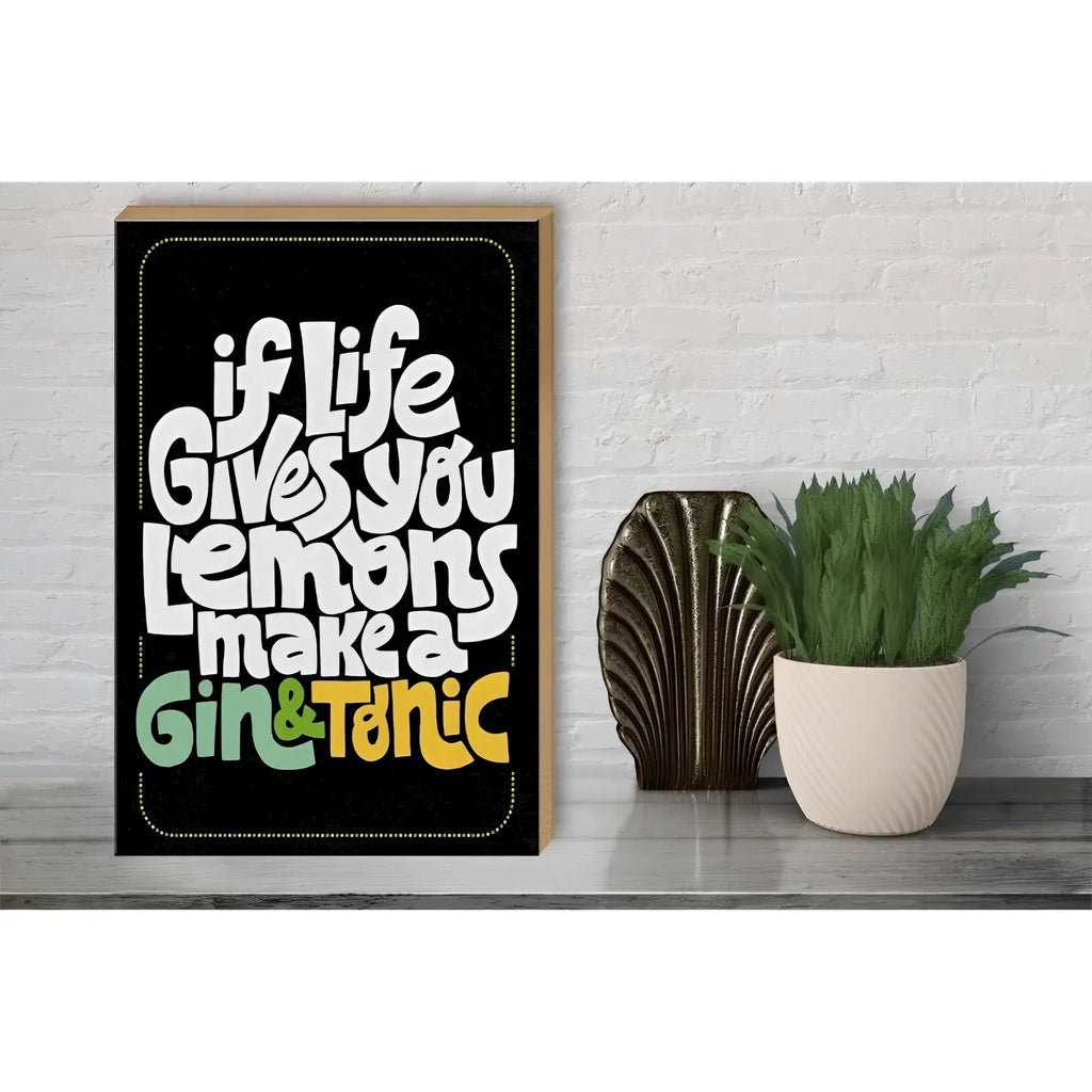 Black framed holzschild with bold white and colorful lettering saying if life gives lemons make gin tonic 30x40cm