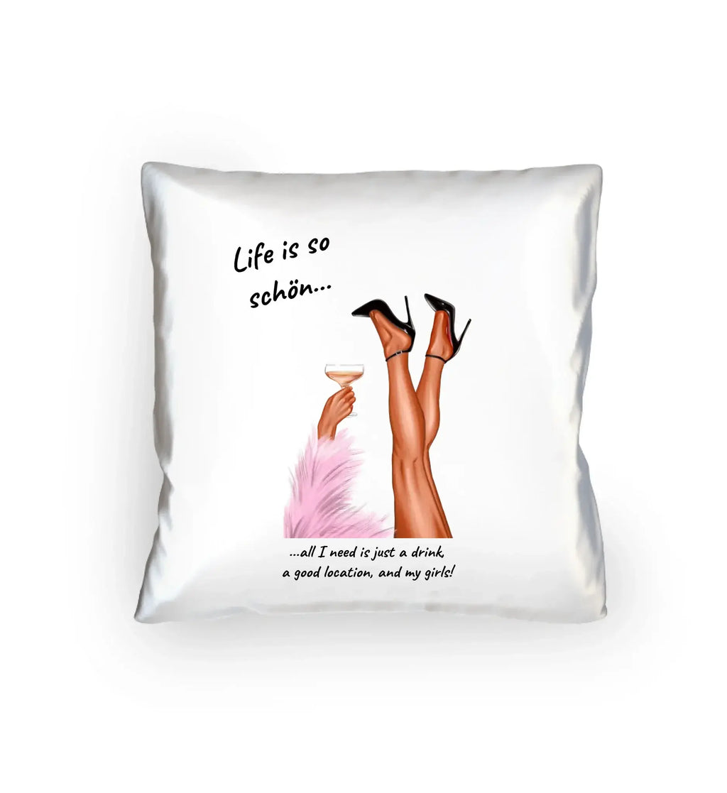 White throw pillow with illustration of legs in black high heels holding champagne glass and text life is so schön from ladies party-beine statement-collection