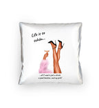 White throw pillow with illustration of legs in black high heels holding champagne glass and text life is so schön from ladies party-beine statement-collection