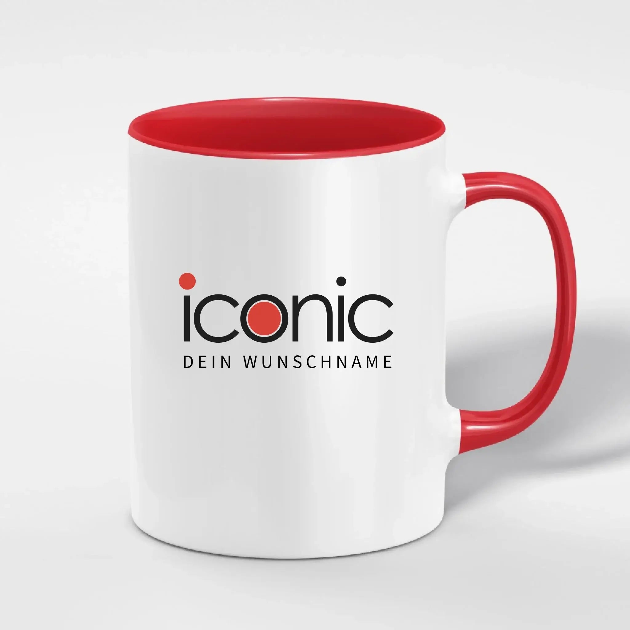 Weiße keramiktasse mit rotem griff und innenfarbe mit ikonischem logo in schwarz und rotem punkt spülmaschinenfest