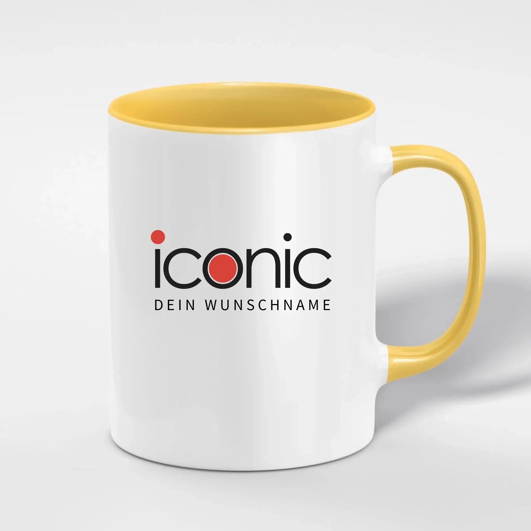 Weiße keramiktasse mit gelbem griff und innenfläche mit schwarzem ikonisch-logo und rotem punkt zweifarbige spülmaschinenfeste tasse