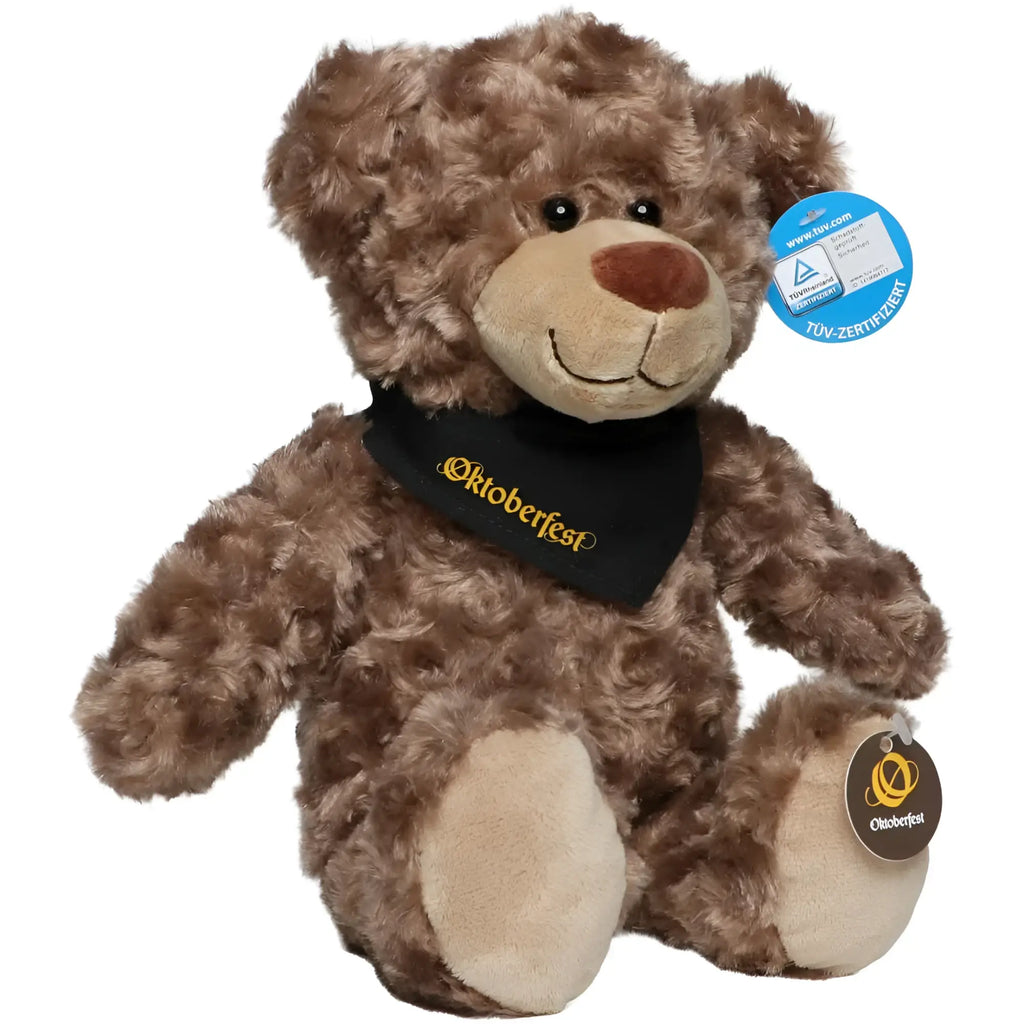 Ein plüschtier bär bodo in braun mit schwarzem oktoberfest bandana und beigen pfoten aus stoff
