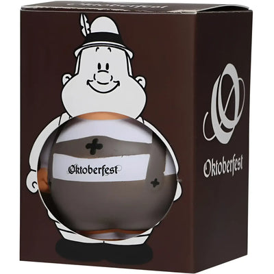 Ein glänzendes dunkelbraunes glas oktoberfest bierflasche mit weißem etikett oktoberfest gehalten von cartoonfigur mit bayerischem hut im oktoberfest geschenkset bert und berta plus 2 lebkuchenherzen