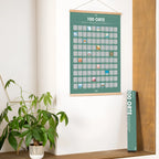 Tealgrünes rubbelposter 100 orte mit holzrahmen an der wand zum freirubbeln der reiseziele in deutscher version