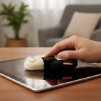 Black and cream plush sock-shaped tablet cleaner with embroidered face from schmoozies displayreiniger gitarre