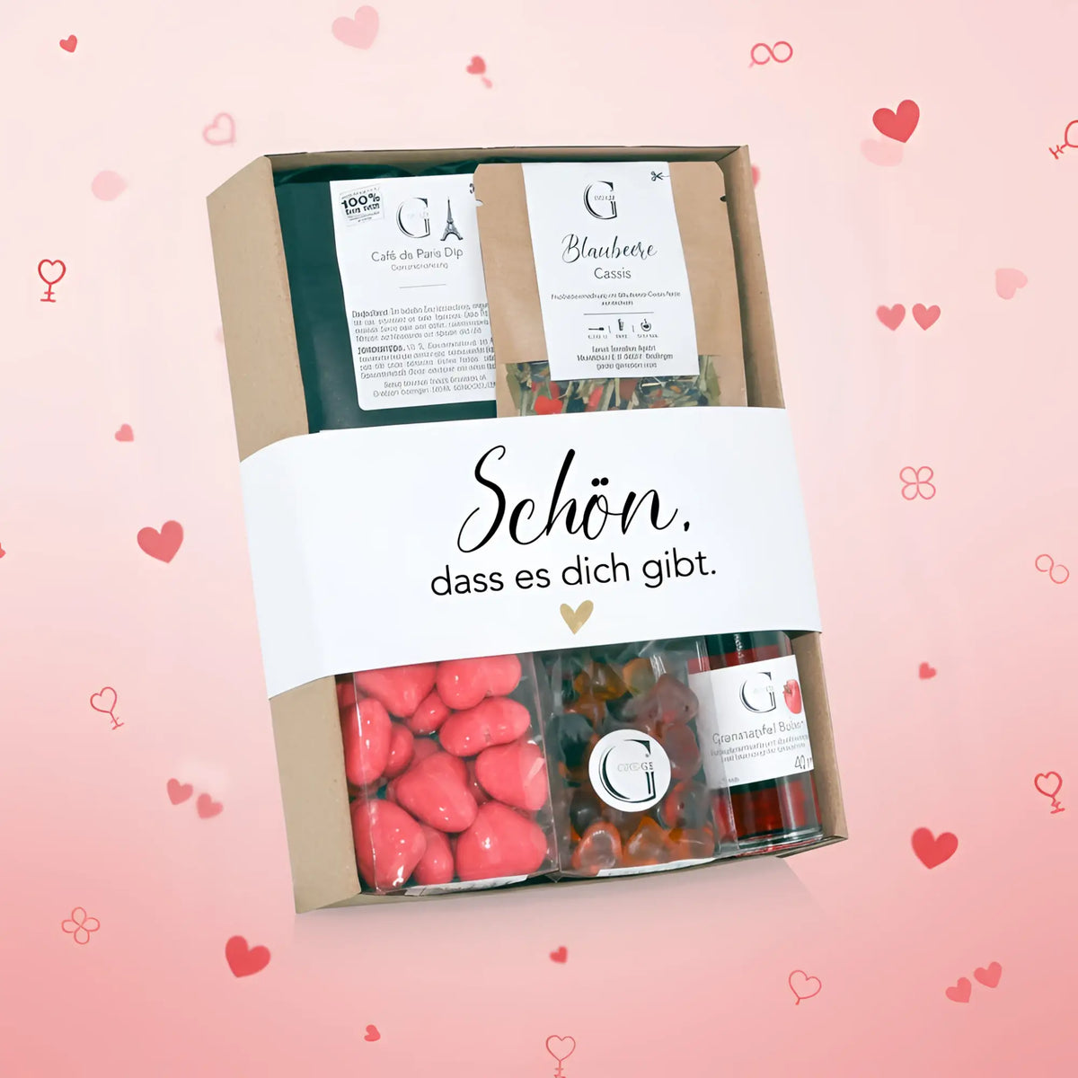 Ein schönes geschenkset präsentkorb mit einer weißen banderole, herzförmigen rosa bonbons und bunten gummy bears