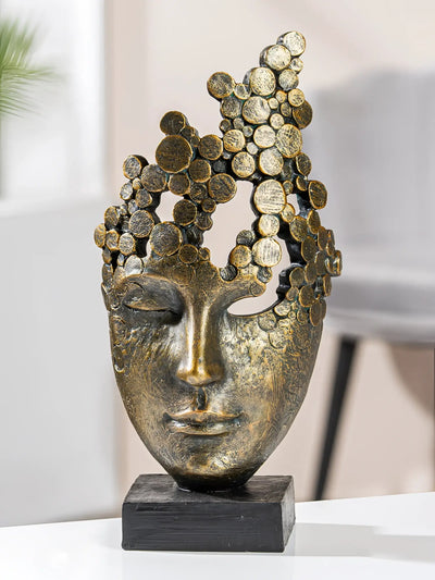 Bronze farbene gesichtsskulptur aus kunstharz mit strukturierter oberfläche und abstrahiertem kronenmotiv von gilde
