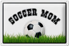 Weiß schwarzer fußball mit klassischen pentagon und hexagon panels liegt auf grünem gras unter soccermom blechschild 20x30cm