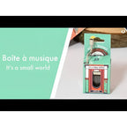 Eine mini spieluhr im vintage jukebox Design mit türkis-orange verpackung namens spieluhr Its Small World