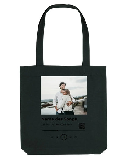 Schwarze leinwandtasche mit fotodruck zweier menschen umarmung und musikplayer text spotify fotomotiv collection