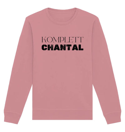 Ein weiches rosa sweatshirt mit langen ärmeln und dem spruch komplett chantal in fetten schwarzen buchstaben