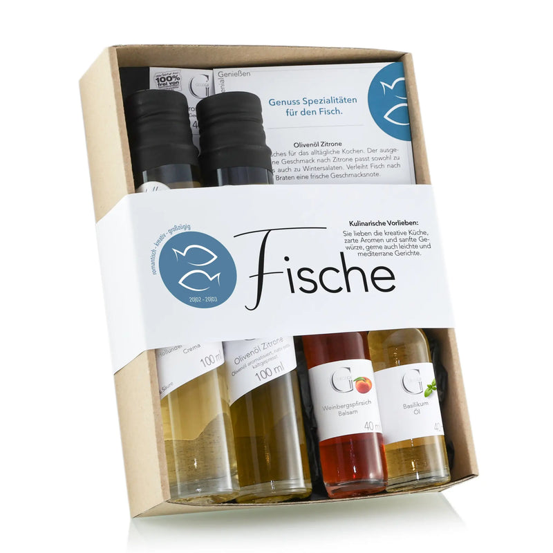 Ein sternzeichen-set für fische mit vier kleinen glasflaschen küchenölen in einer geschenkbox aus karton