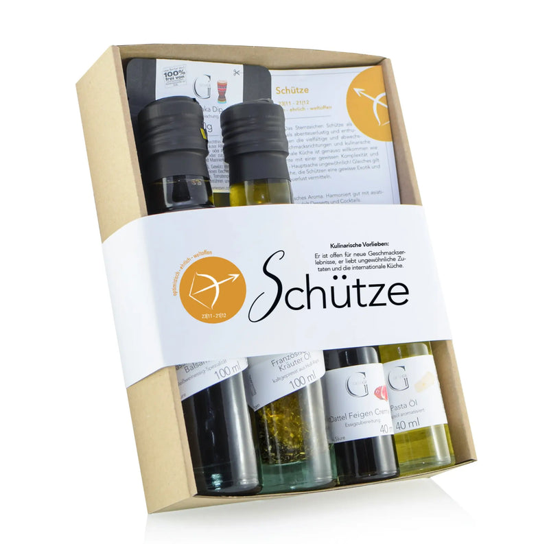 Giftset schütze mit vier kleinen glasflaschen olivenöl und balsamico mit schwarzen deckeln im präsentkorb