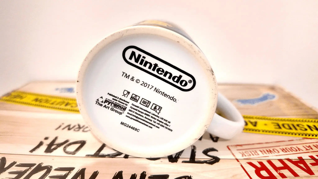 Weiße keramiktasse mit nintendo logo und copyright auf der unterseite super mario ii tasse offizielles lizenzprodukt