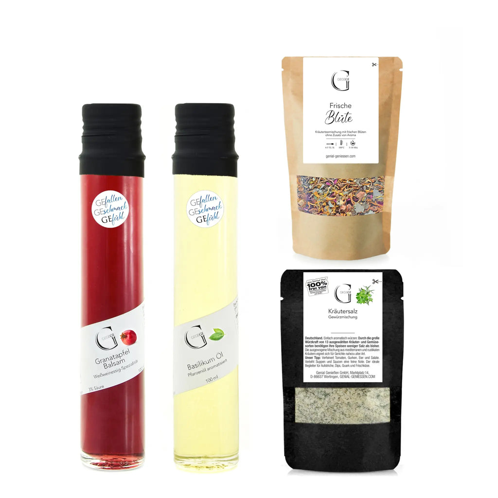Zwei glasflaschen mit schwarzen kapseln, eine mit rotem granatapfel balsam und eine mit gelbem basilikum öl im vielen dank geschenkset