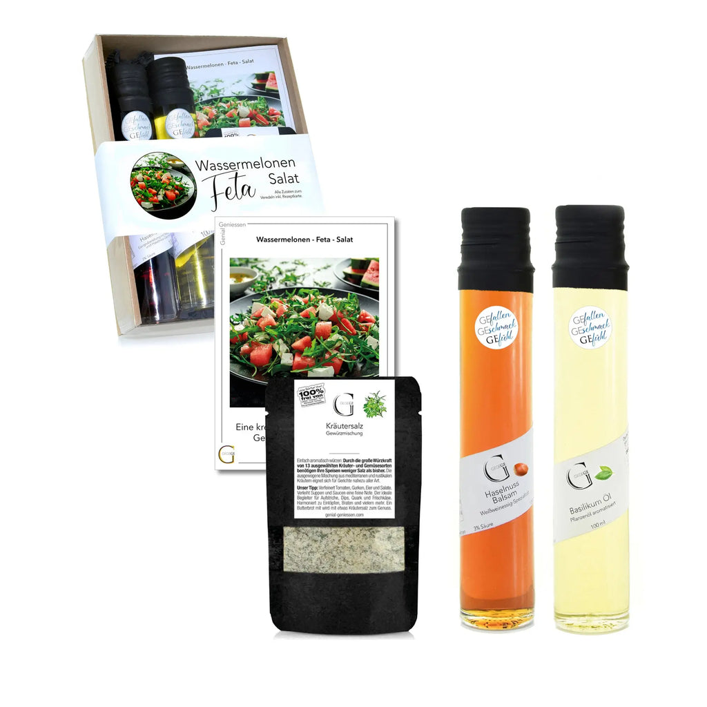 Ein geschenkset mit zwei glasflaschen aromatisierter öle in orange und hellgelb für wassermelonen feta salat