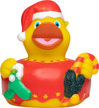 Gelbe quietsche-ente mit rotem santa-hut hält zu weihnachten zuckerstangen grüne socke und tannenzweige