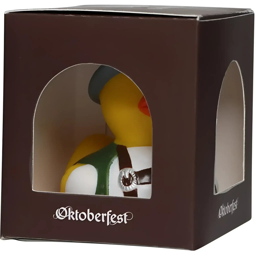 Gelbe badeente mit grüner und weißer oktoberfest-tracht und dunkler mütze mit silberner schnalle von schnabels