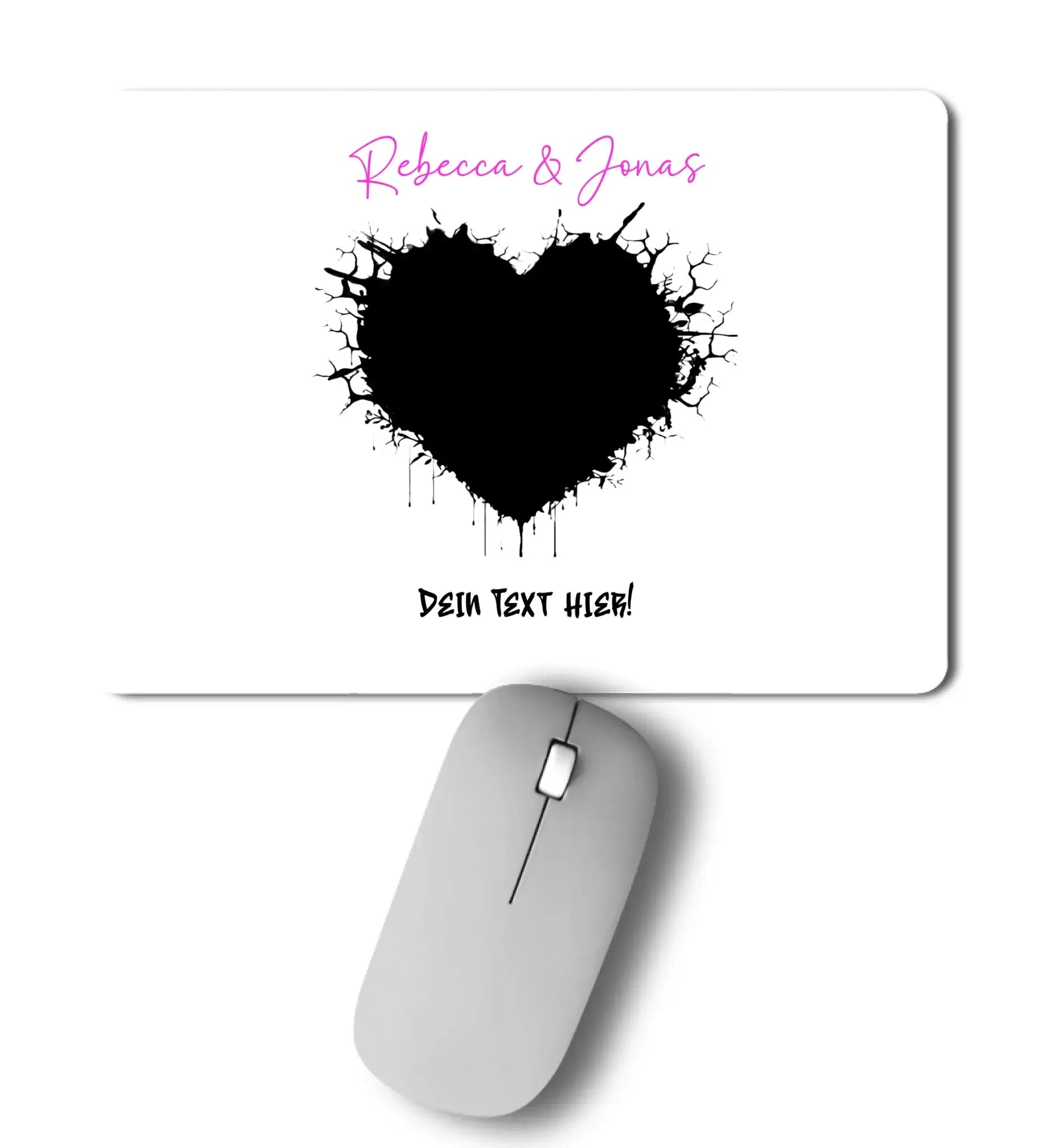 Weiße mousepad mit schwarzem tintenherz und pinkem wunschtext aus der statement-collection mit silberner wireless-maus